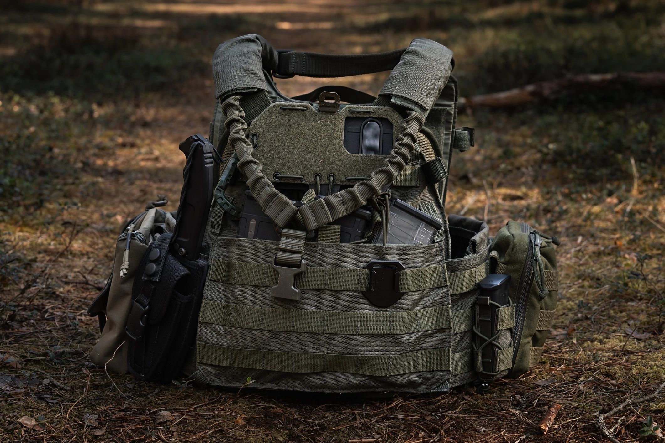 Tactical vest and pouches in a forest setting
